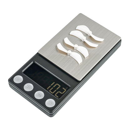 White 40mm 2-blade props on digital scale showing 10.2 g weight reading