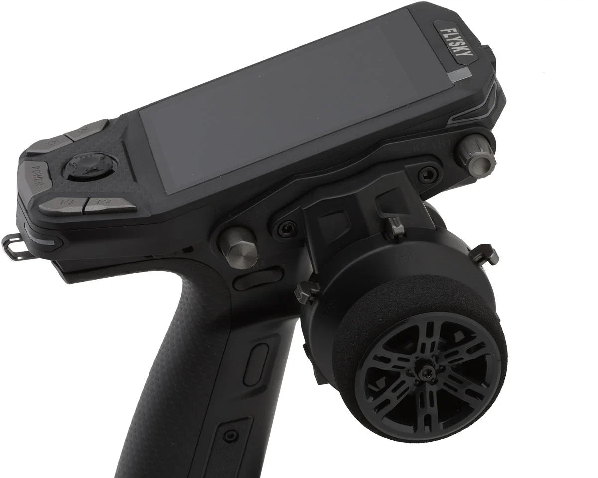 Flysky FS-G11P surface RC transmitter close-up showing steering wheel and top display panel
