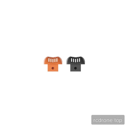 Orange and black slotted decorative prop-guard pieces, each with a lower tab and circular mounting hole.