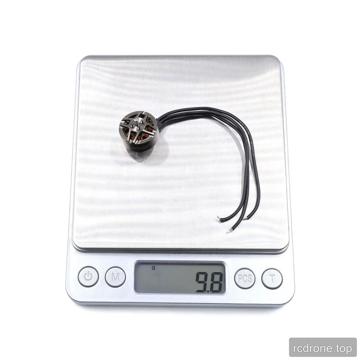 GEPRC GR1404 motor and three lead wires placed on a digital scale displaying 9.8 g.