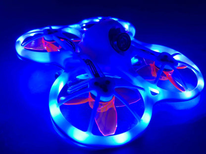 FPV drone with blue LED strip lighting installed around ducts, glowing in low light