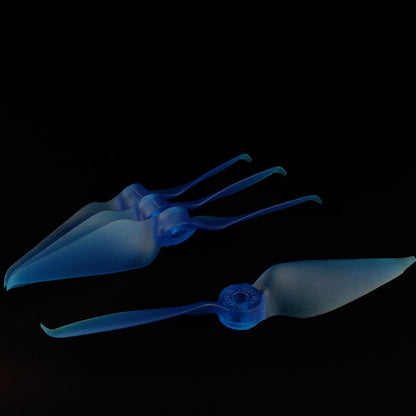 Translucent blue 2-blade FPV racing propeller set, four stacked props plus one laid flat
