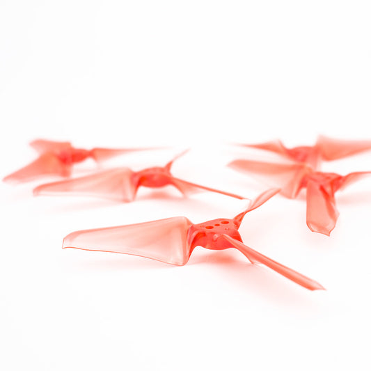 EMAX AVAN Mini 3-inch tri-blade propeller close-up in translucent red, 3x2.4x3