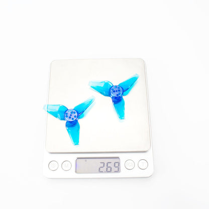 Two blue 3-blade propellers on digital scale showing 26.9 g total weight reading