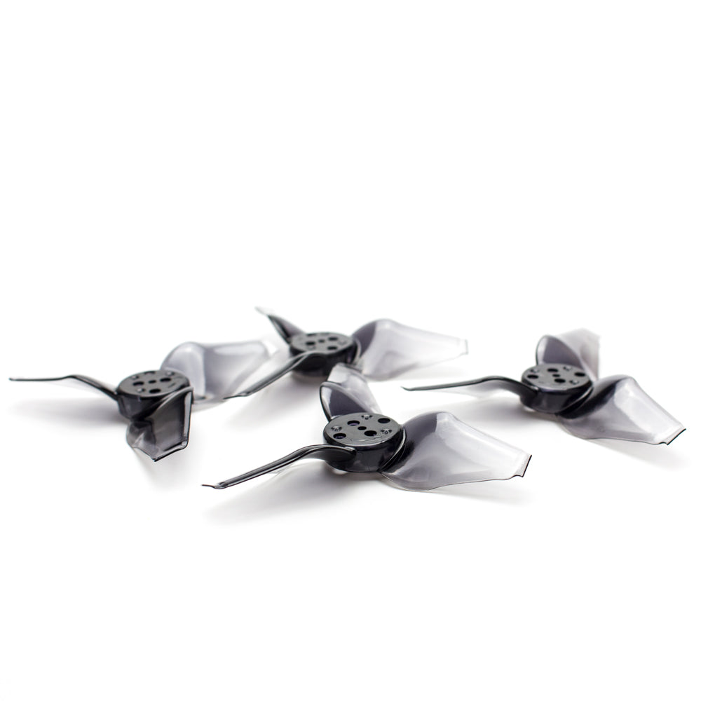 Smoky black/gray 3-blade micro drone propellers with 5-hole hub, angled view
