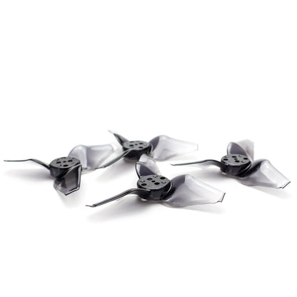 Smoky black/gray 3-blade micro drone propellers with 5-hole hub, angled view