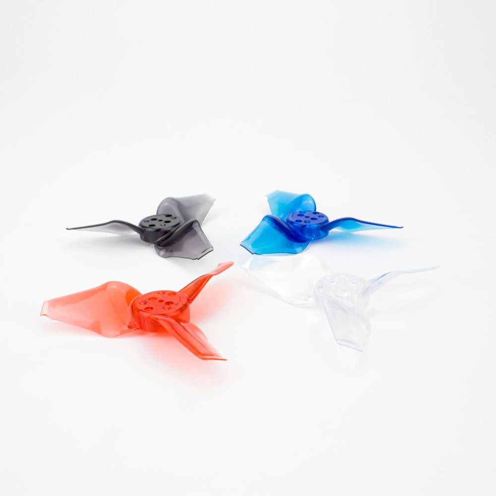 Assorted color propellers shown together: red, black/gray, blue, and clear tri-blades