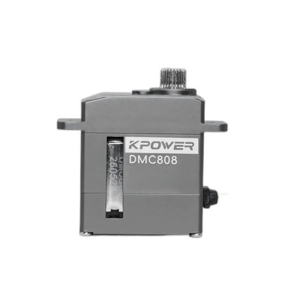 DMC808 servo viewed straight on, with its side label, narrow casing opening, upper splined shaft, and mounting tabs visible.