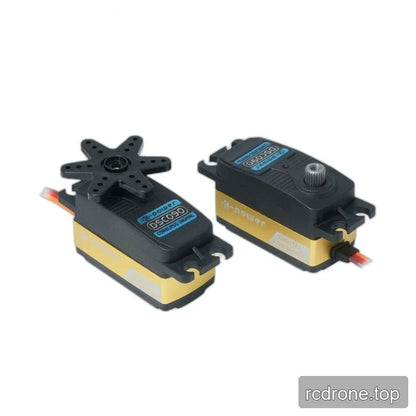 Two black and gold DSC090 servos side by side, showing a six-arm horn on one and an exposed splined shaft on the other.