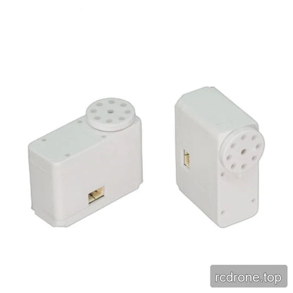 Two white servo views side by side in horizontal and upright orientations, showing circular output discs and side connectors.