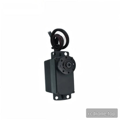 Upright servo showing the circular output flange, upper and lower mounting tabs, ribbed left side, and coiled cable above.