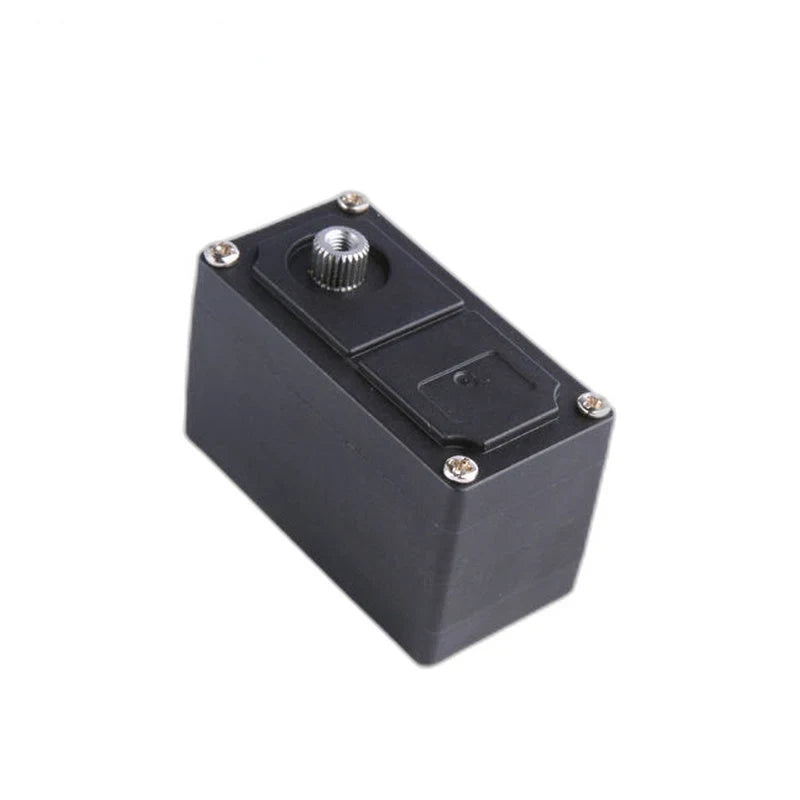Angled view of the black servo with its narrow end forward and silver splined shaft at the upper left.
