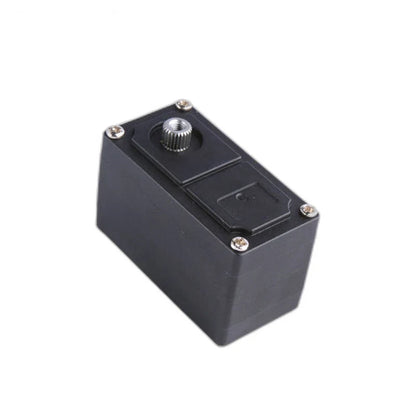 Angled view of the black servo with its narrow end forward and silver splined shaft at the upper left.