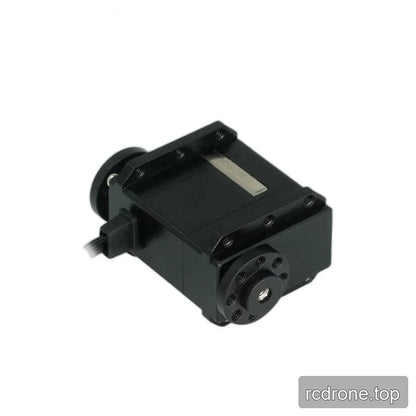 Angled black servo showing the circular multi-hole end fitting, threaded mounting rails, and cable connection on the left.