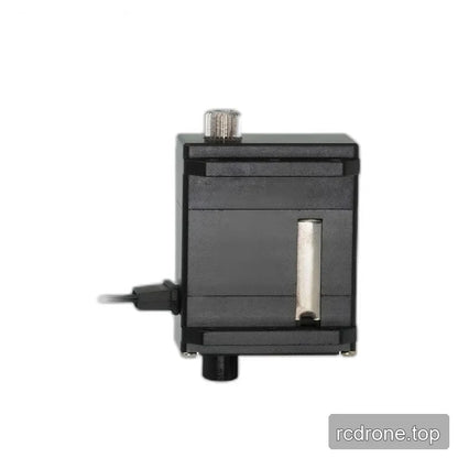 Side view of the black servo with exposed silver splined shaft, vertical silver strip, mounting rails, and left cable exit.