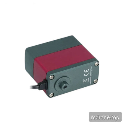 Servo underside with a round threaded projection, four corner screws, CE marking, and cable beside the red casing.
