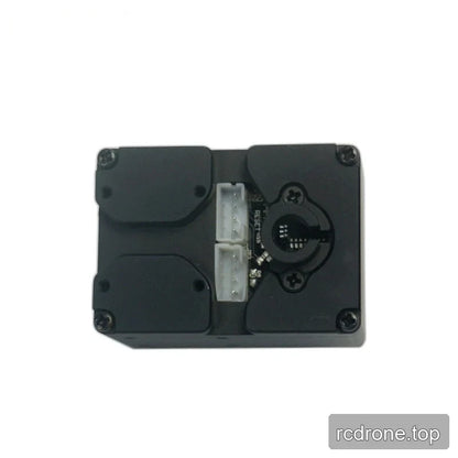 Servo face showing two white connectors, exposed circuit board sections, and a circular opening with retaining screws.