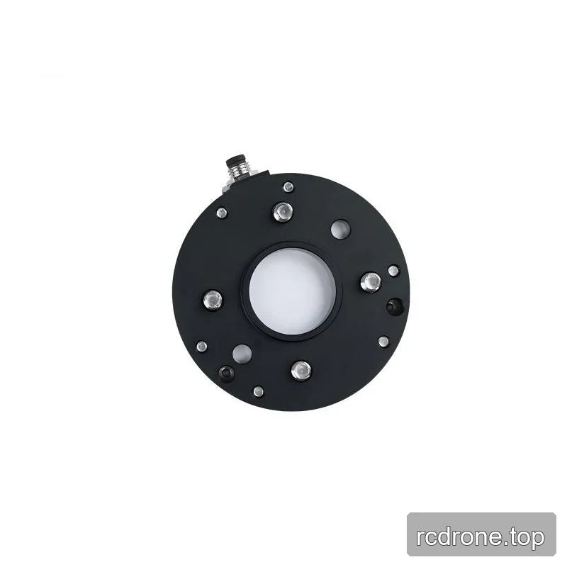 Straight-on underside view of the black sensor plate with a central opening, four silver stud ends and surrounding holes.