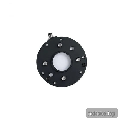 Straight-on underside view of the black sensor plate with a central opening, four silver stud ends and surrounding holes.