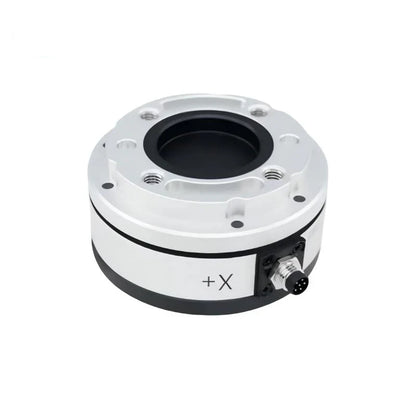 Silver circular sensor with recessed black center, threaded mounting holes, +X marking, and right-side connector.