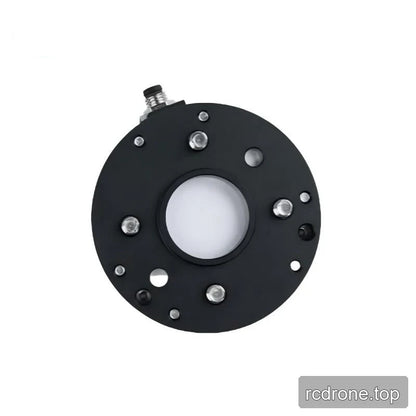 Black underside of the sensor with a central opening, silver fasteners, surrounding holes, and an edge connector.