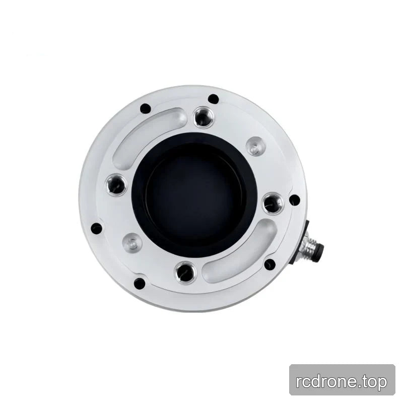 Top face of the circular sensor showing threaded holes, curved machined recesses, and a black central opening.
