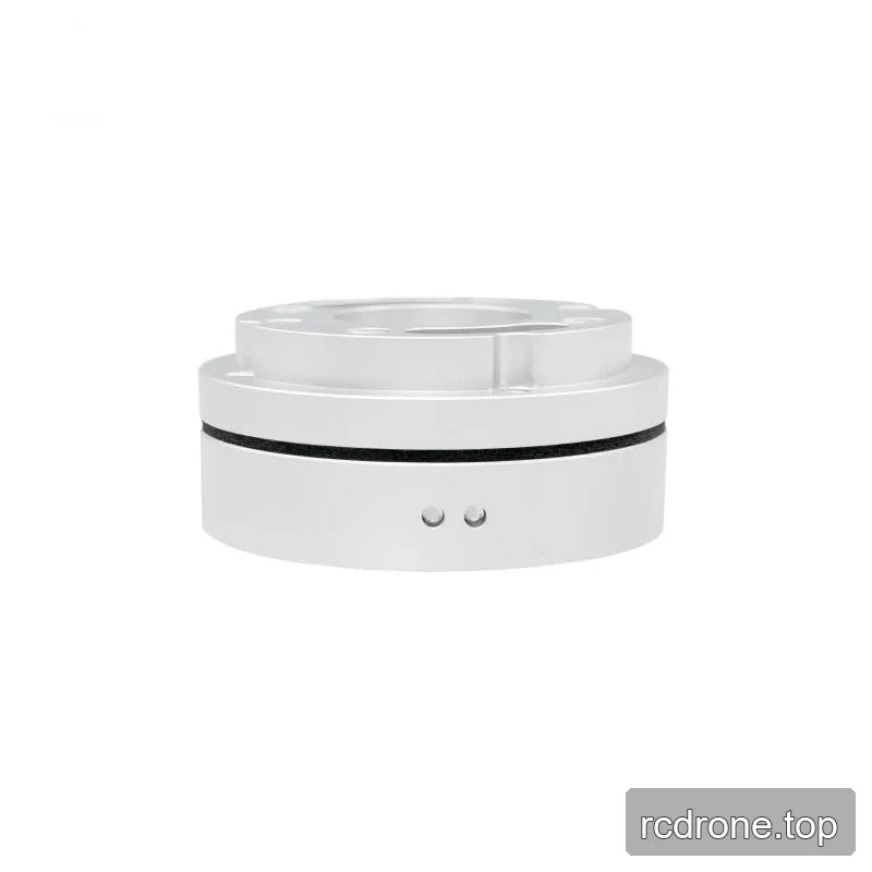 Low side view of the silver sensor showing a raised top flange, black circumferential seam, and two small circular side details.