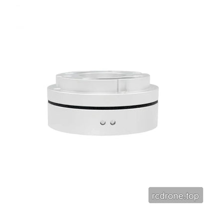Low side view of the silver sensor showing a raised top flange, black circumferential seam, and two small circular side details.