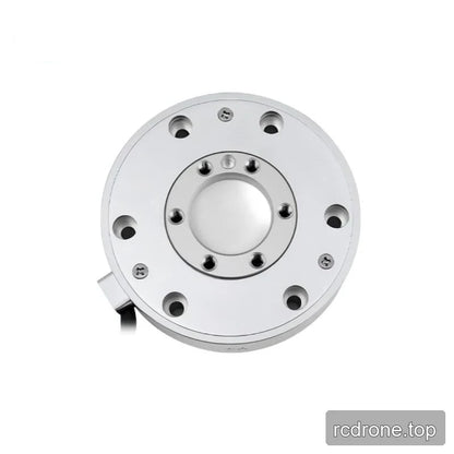Near-overhead view of the sensor face with concentric rings of mounting holes and a cable outlet at the lower left.