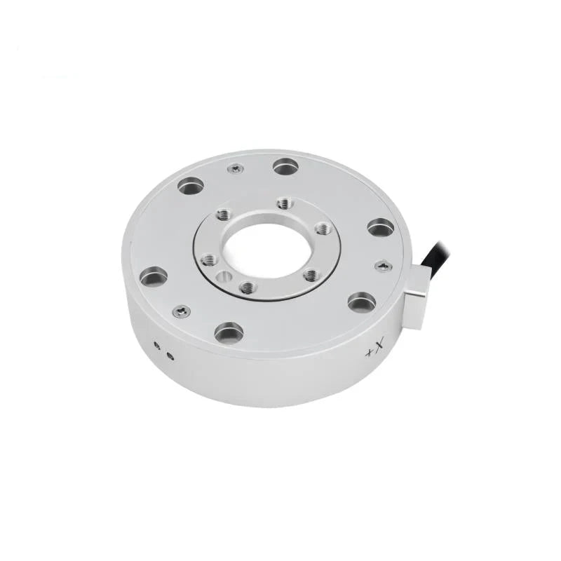 Silver circular sensor with a central opening and concentric mounting holes, viewed at an angle with the cable on the right.