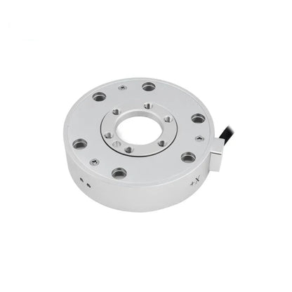 Silver circular sensor with a central opening and concentric mounting holes, viewed at an angle with the cable on the right.