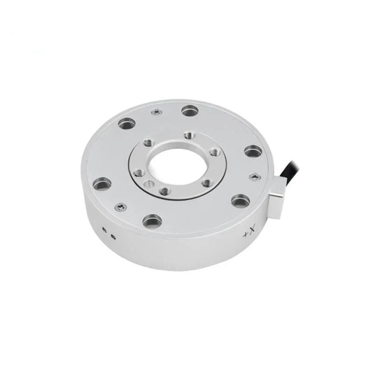 Silver circular sensor with a central opening and concentric mounting holes, viewed at an angle with the cable on the right.