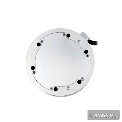 Underside of the circular sensor with a solid cover plate, perimeter screws and mounting holes, and a cable at upper right.