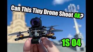 Firefly16 1S nano baby tiny FPV drone with front camera on a small carbon frame, held in hand