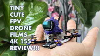 Palm-sized micro FPV drone with a front-mounted camera and compact frame resting on a hand