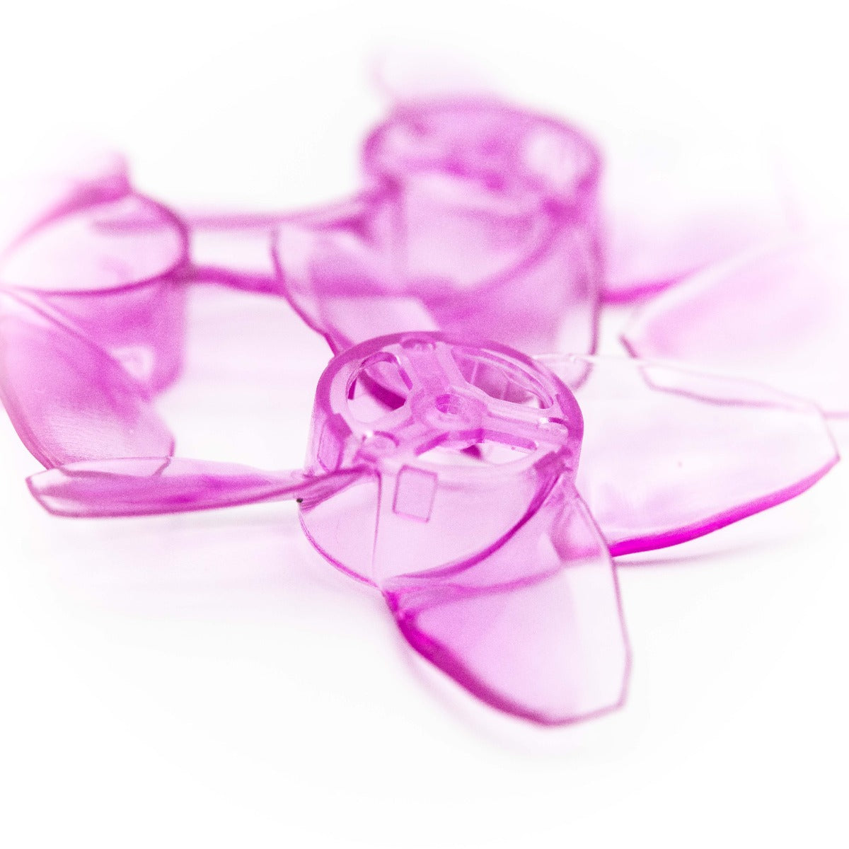 Close-up of purple 40mm quadcopter propeller showing 4-blade hub and blade shape