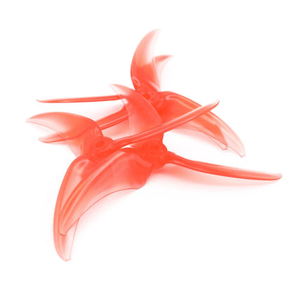 Set of red translucent EMAX Avan Scimitar 5030 tri-blade 5-inch propellers stacked on white background