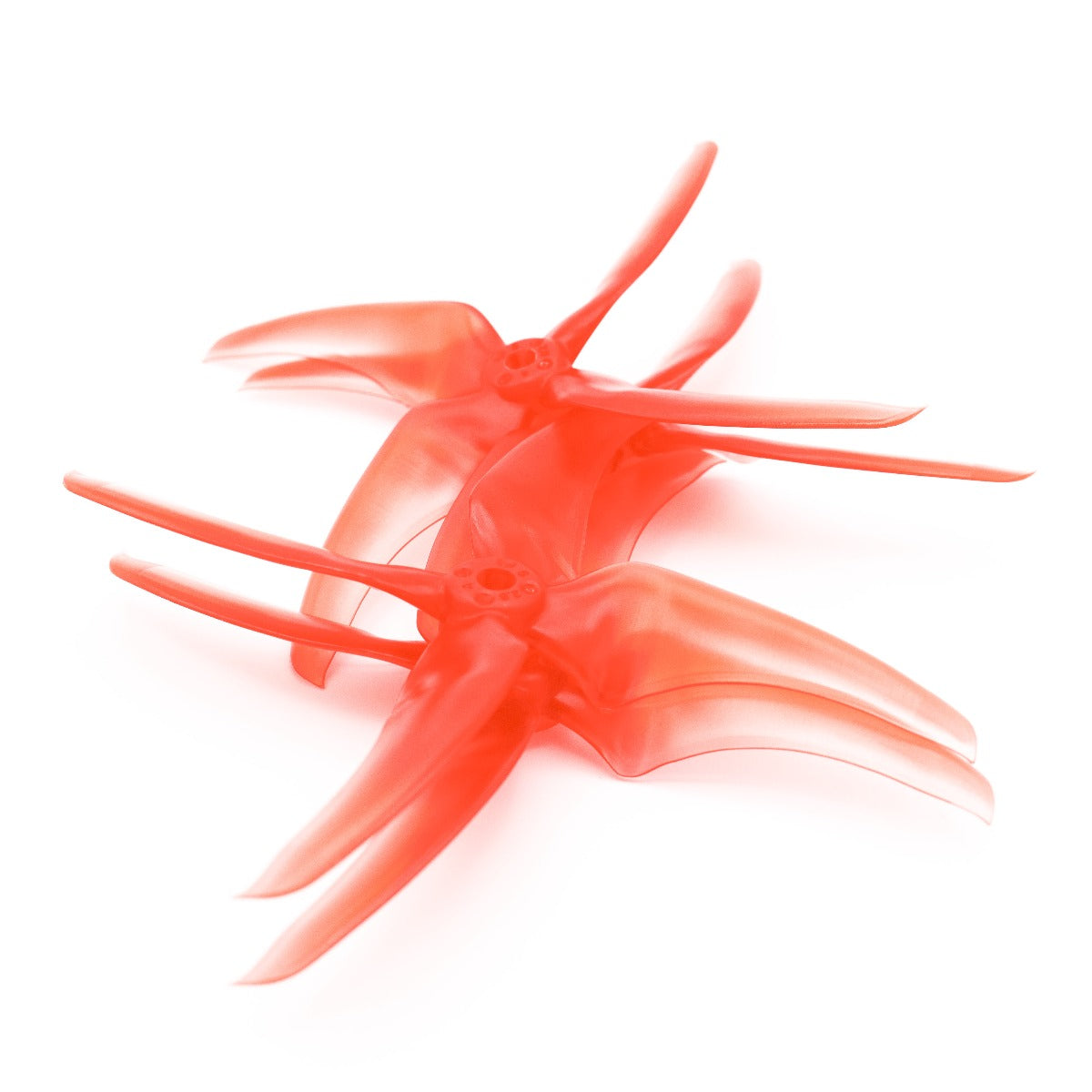 Two translucent red 4-blade drone propellers stacked, angled view of hubs and blades