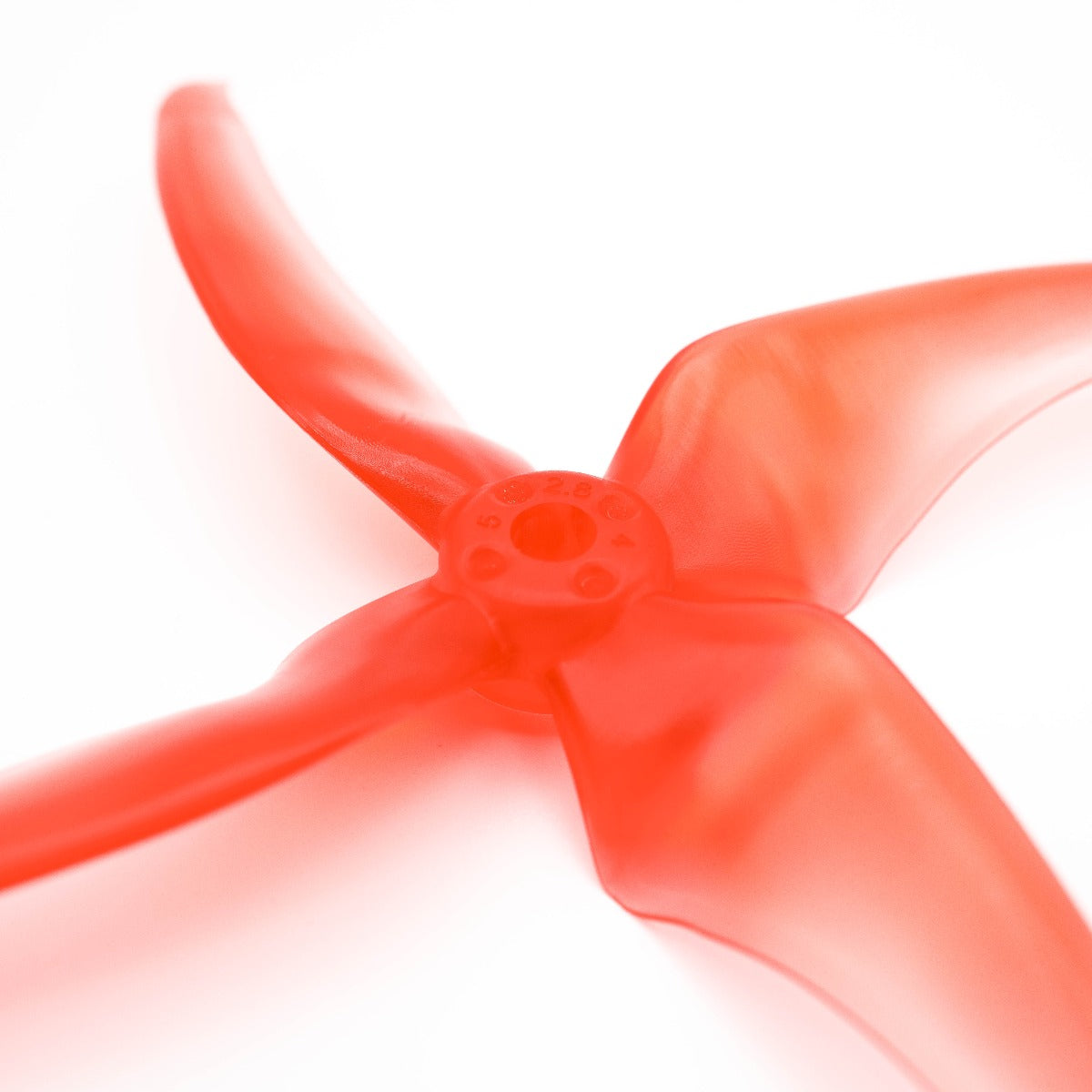 Close-up of propeller hub and blade root on translucent red 4-blade prop