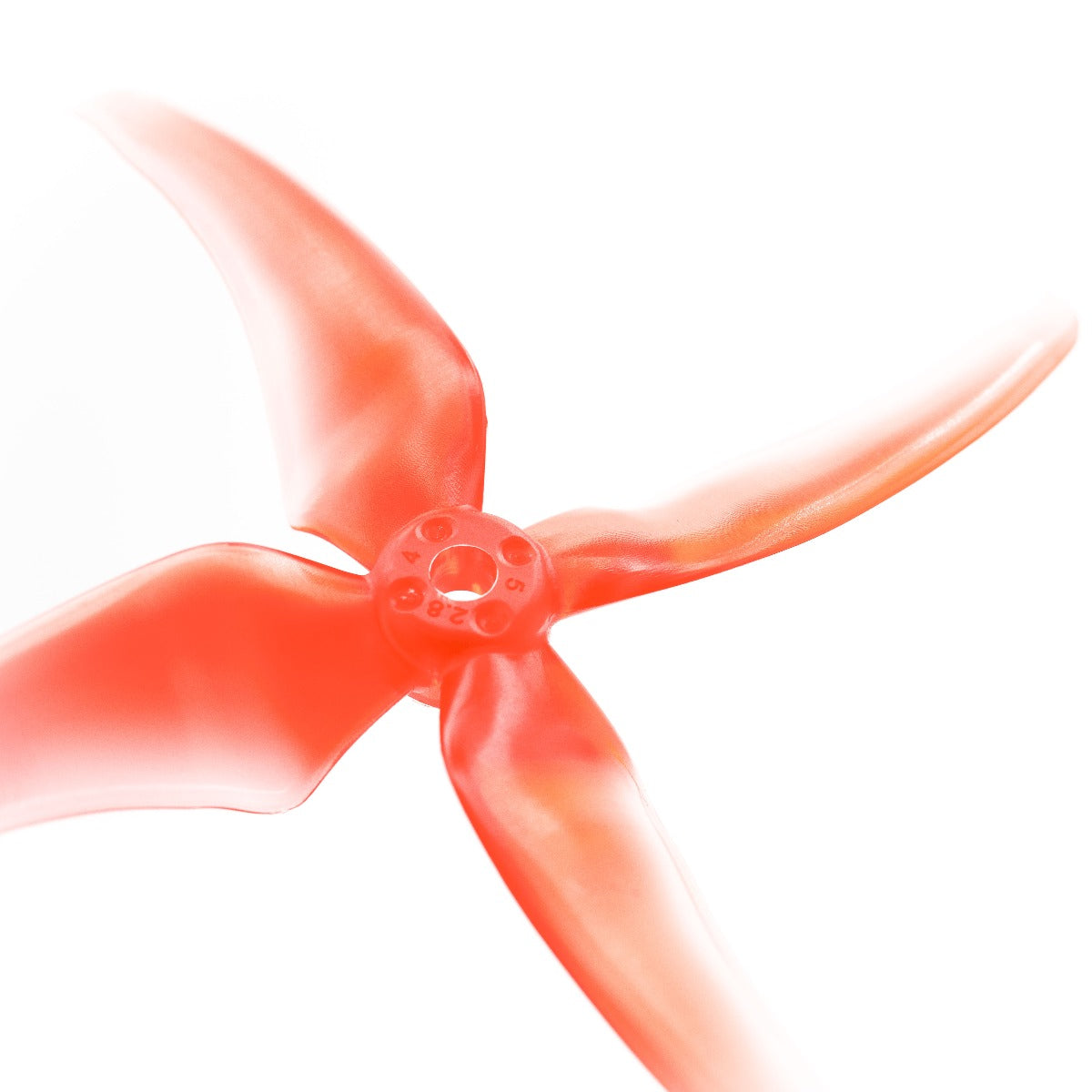 Angled close-up of translucent red 4-blade propeller hub with molded markings