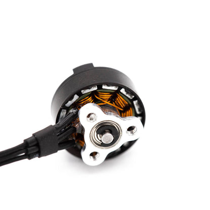 Bottom view of EMAX 0802 motor showing mounting base plate, shaft bearing, and solder pads with wires