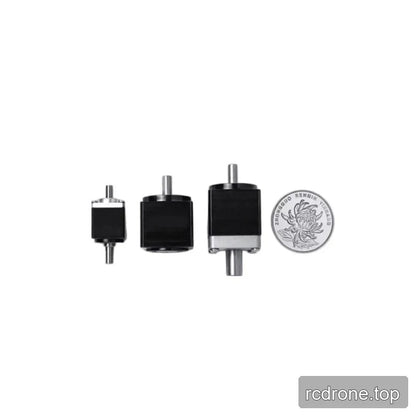 Three compact black shaft reducers shown beside a Chinese 1 yuan coin for relative size comparison.