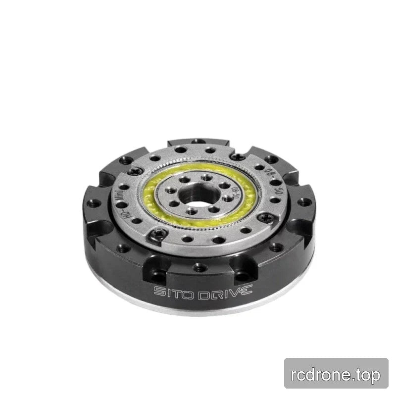 Angled top view of the SITO DRIVE reducer showing its low-profile black housing, silver face, central bore, and yellow ring.
