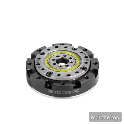 Angled top view of the SITO DRIVE reducer showing its low-profile black housing, silver face, central bore, and yellow ring.