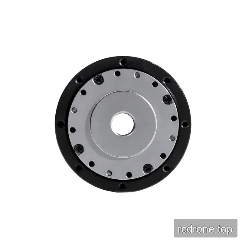 End-on view of the TA-52 actuator showing a circular silver mounting plate, central bore, bolts, and black outer ring.